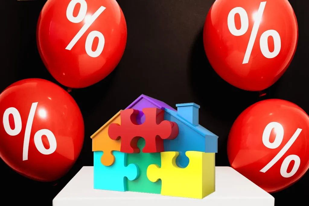 casinha feita de puzzle com balões vermelhos ao fundo com o símbolo da percentagem desenhado