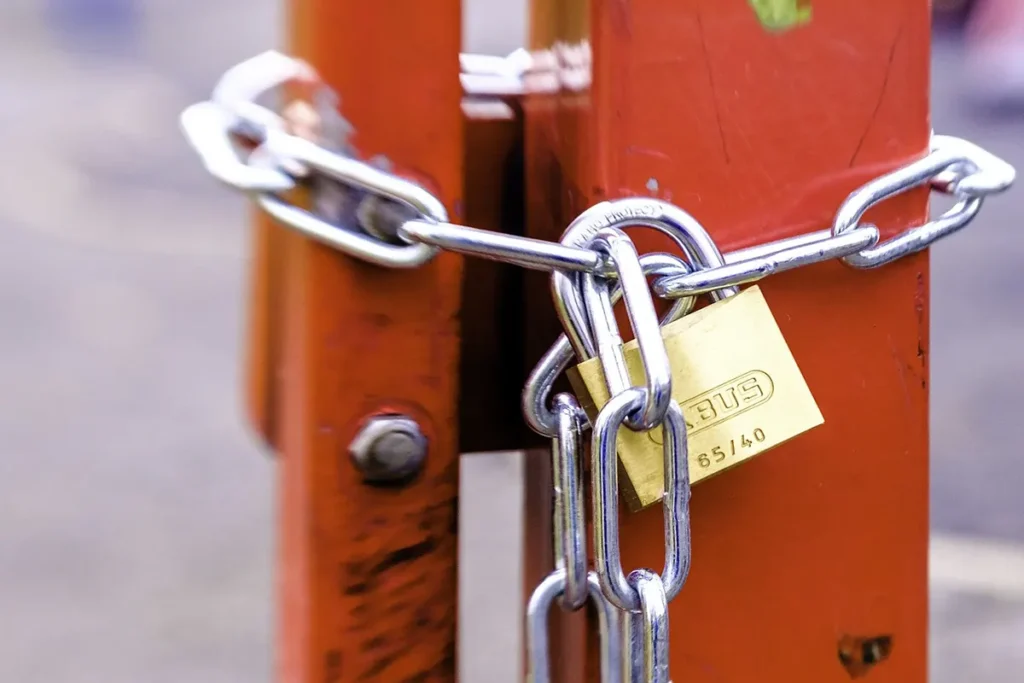 Real Estate Purchase Offer Contingent on Mortgage Approval close-up of a padlock with a chain locking a gate